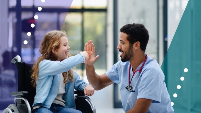 Doctor greets young patient at complex pediatric care facility 