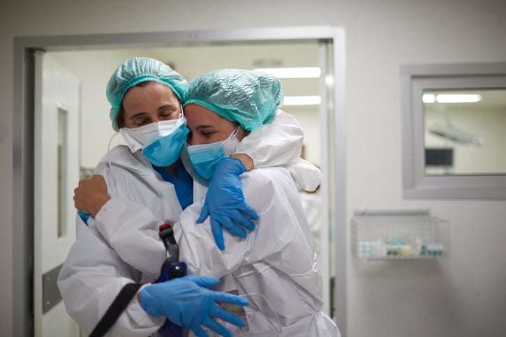 Two nurses hugging