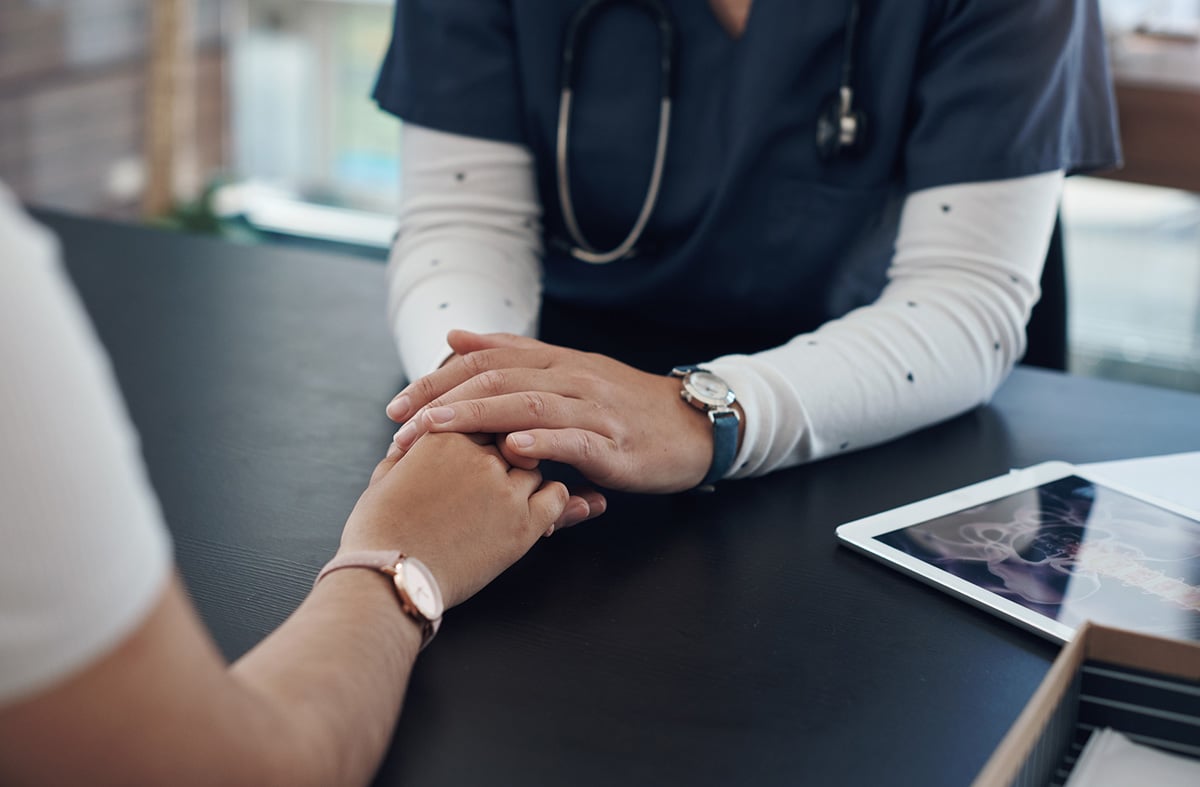 nurse holding patient hand