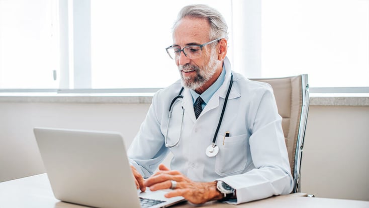 Physician uses laptop to access EHR training program