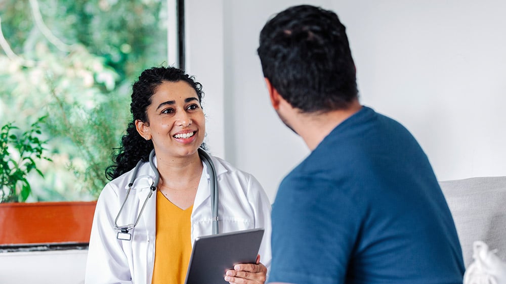 Physician in appointment with patient using MaaS on a tablet