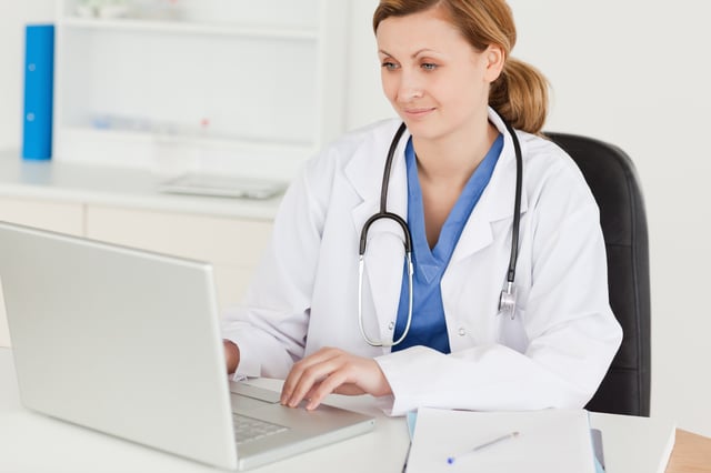 doctor working on her laptop in her office