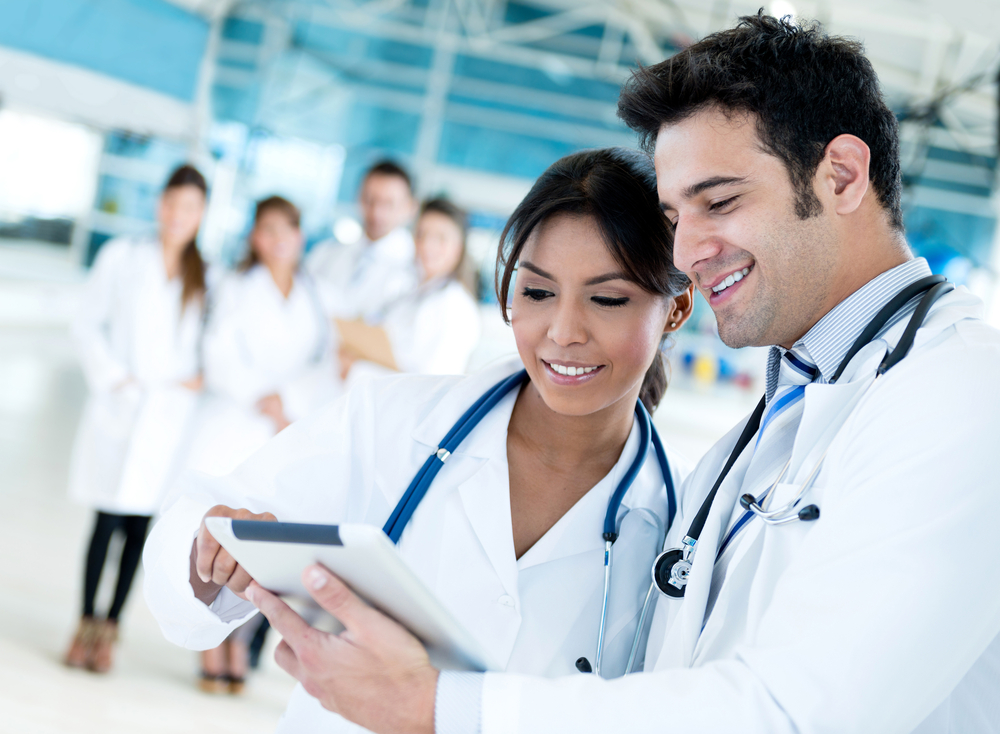 Couple of doctors talking and using a tablet computer-1