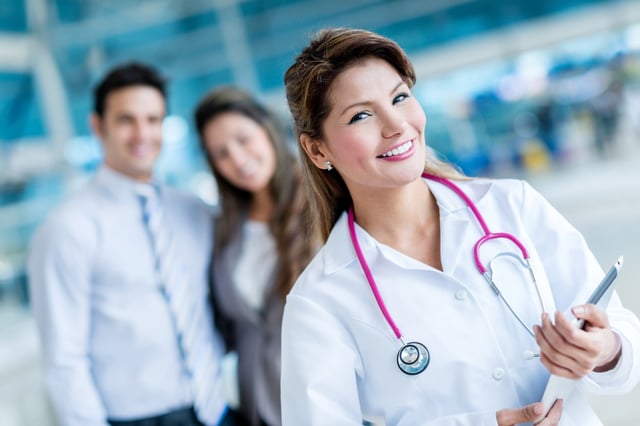 Family doctor at the hospital with patients at the background.jpeg