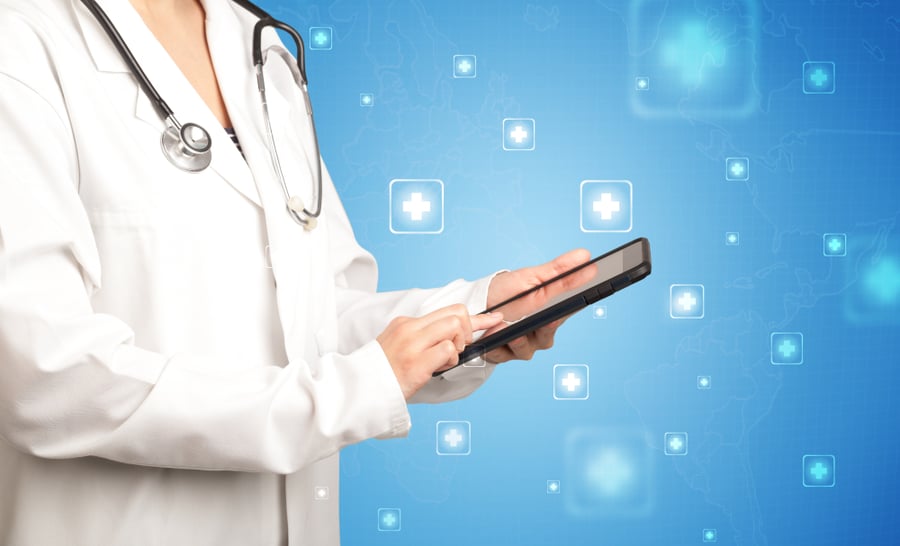 Female doctor holding tablet with blue background and crosses