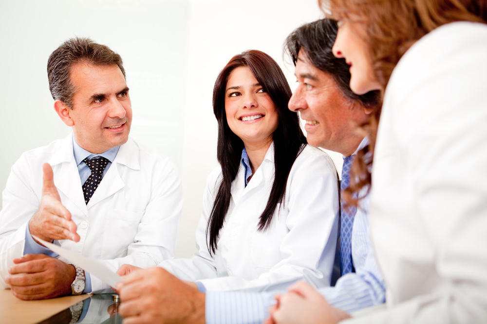 Group of doctors in a meeting with business people negotiating medical insurance