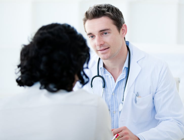 Doctor talking with his patient for the annual check-up in the hospital