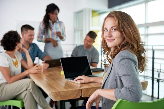 Image of a succesful casual business woman using laptop during meeting.jpeg