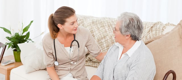 Nurse talking with her patient at home