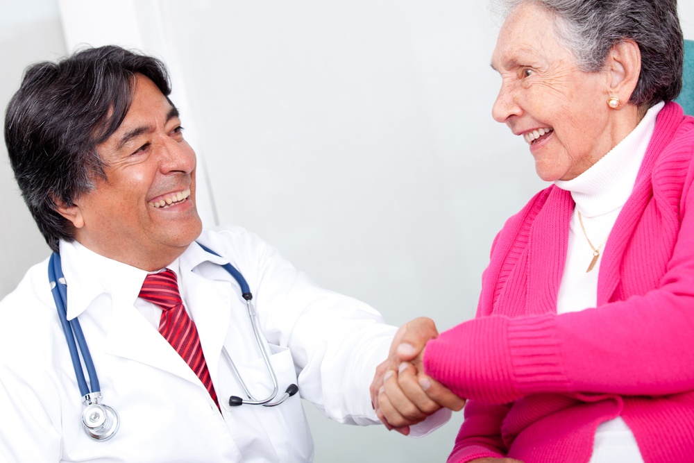 Old woman handshaking with a friendly doctor