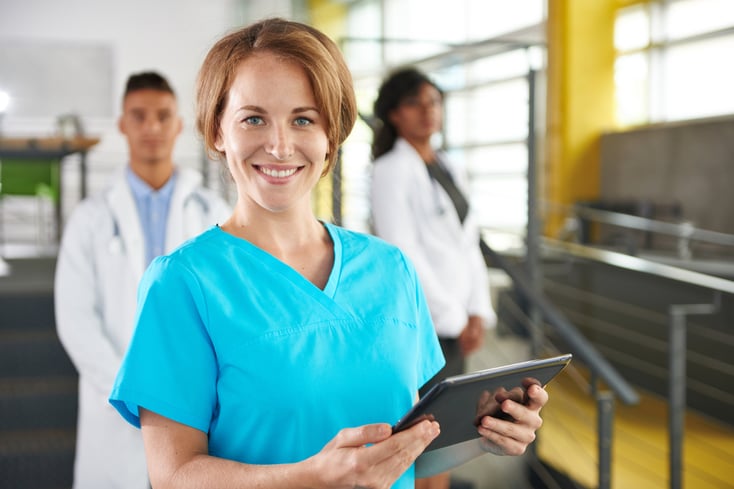 Portrait of a friendly caucasian female doctor and team in bright modern office-4