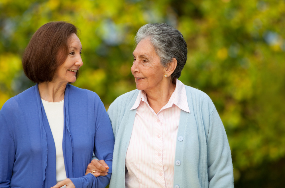 Portrait of an elder mother and daughter walking outdoors