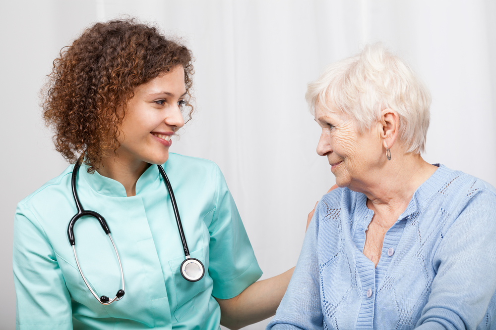 Smiling nurse and happy elderly lady, horizontal-1