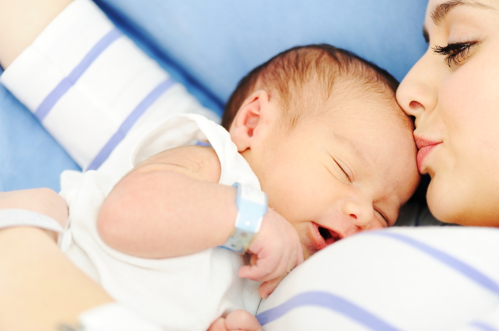 Woman holding her 2 days old newborn baby