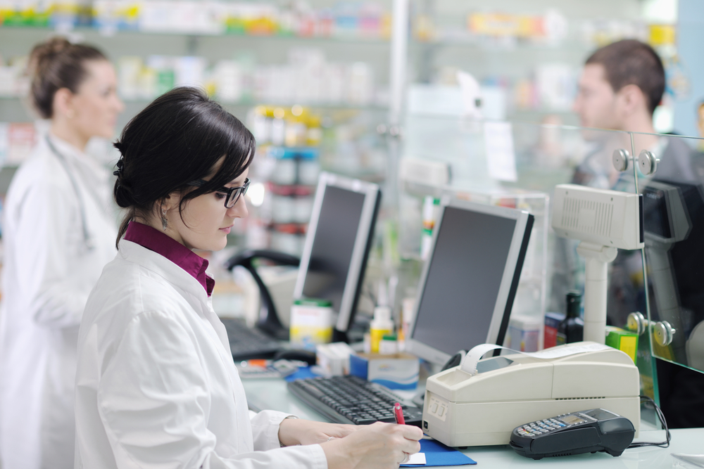 young pharmacist suggesting medical drug to buyer in pharmacy drugstore