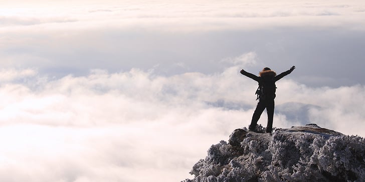 person-with-hands-up-on-mountain-top--blog